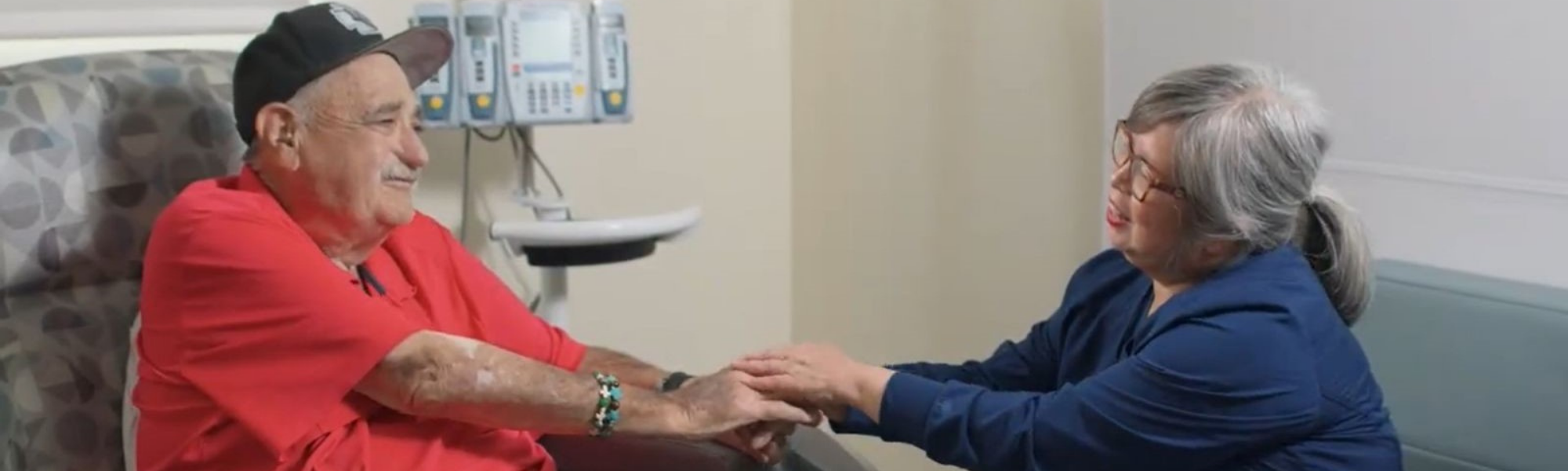 Cancer patient holding hands with family member